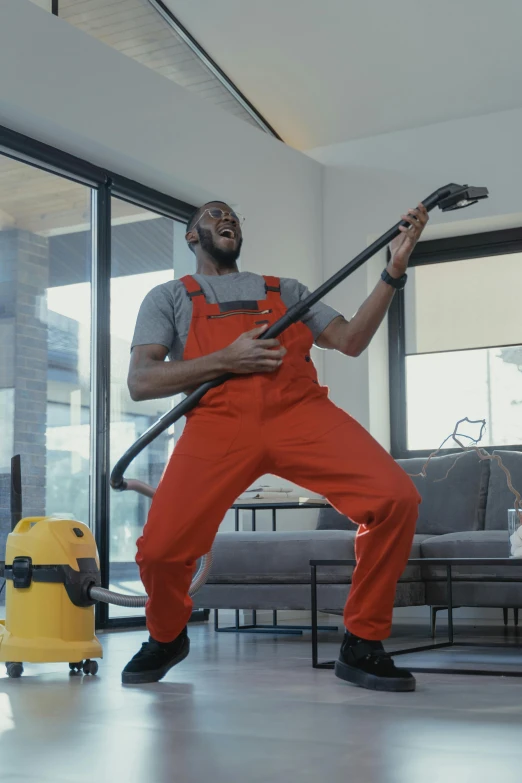 a man cleaning a living room with a professional vacuum