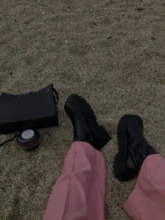 an empty wallet is laying next to some black shoes