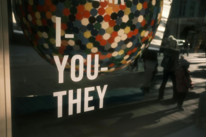 the words, i, you, they are printed in large letters on a glass window