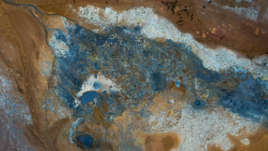 a blue substance sitting on top of a brown substance