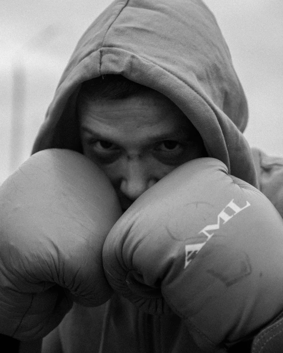 a man in a hooded jacket and boxing gloves