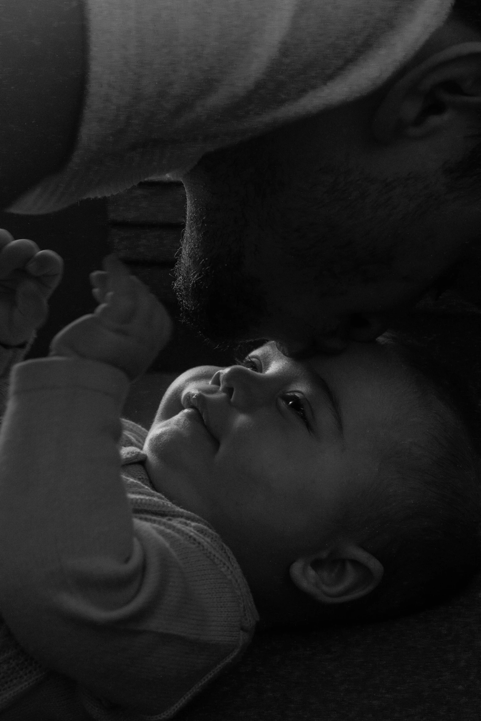 an infant is laying down on the floor playing