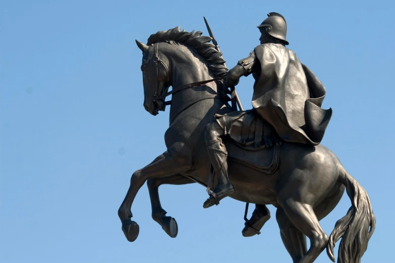 a statue of a man riding on top of a horse