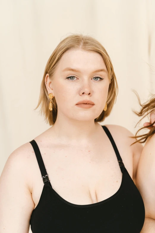 a close up of a person wearing a black top