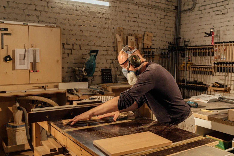 a man with a visor working in a shop