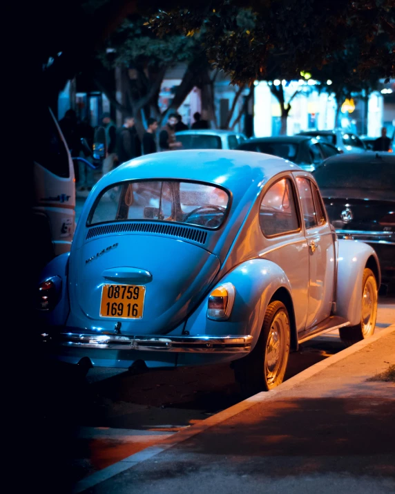 an old blue beetle parked next to a building