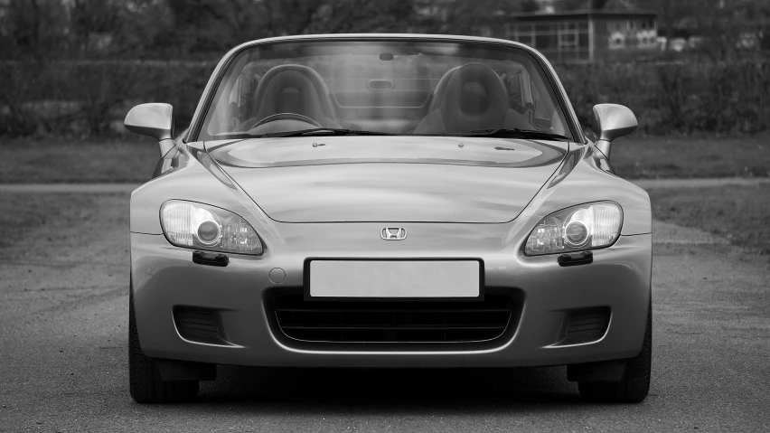 a silver sports car sitting on the street