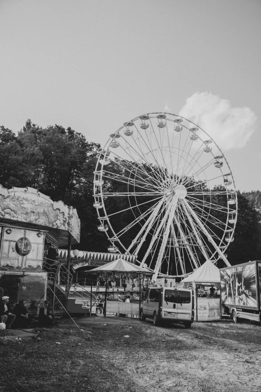 a carnival park filled with ferris wheel and fair tents