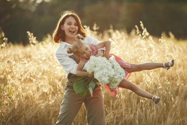 there is a woman carrying a small boy