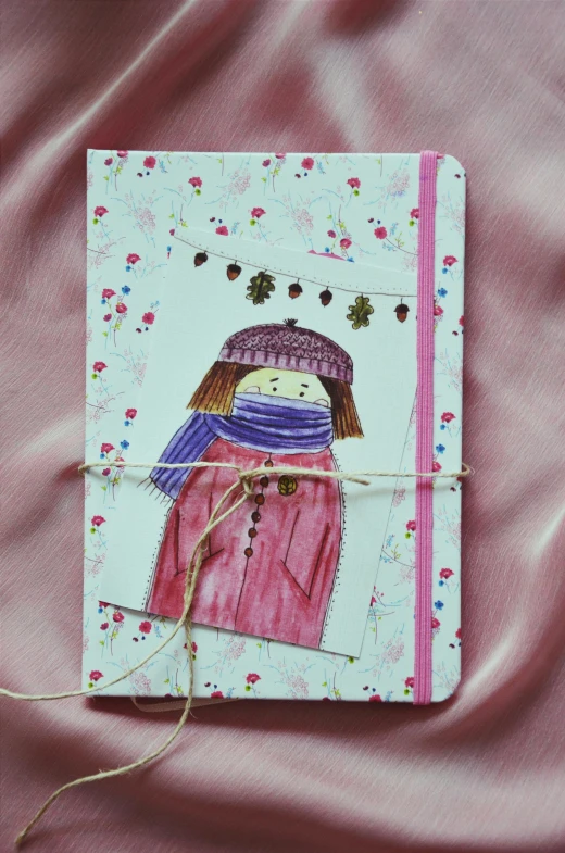 the notebook has a picture of a girl with a scarf