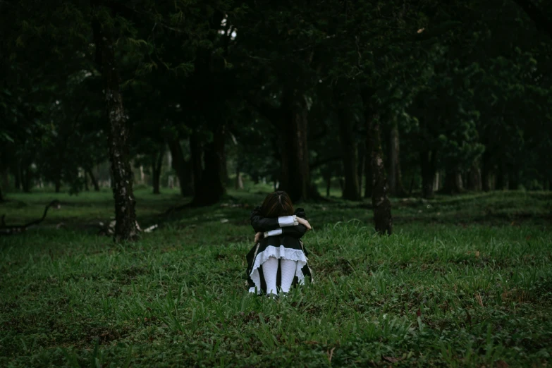 a person sits alone in the woods while looking at soing