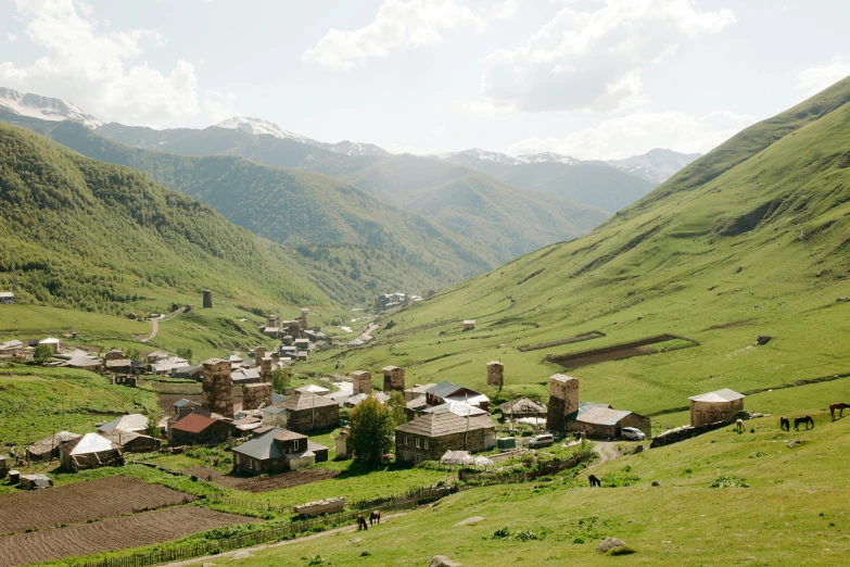 the mountain village in the valley is nestled among many lush hills