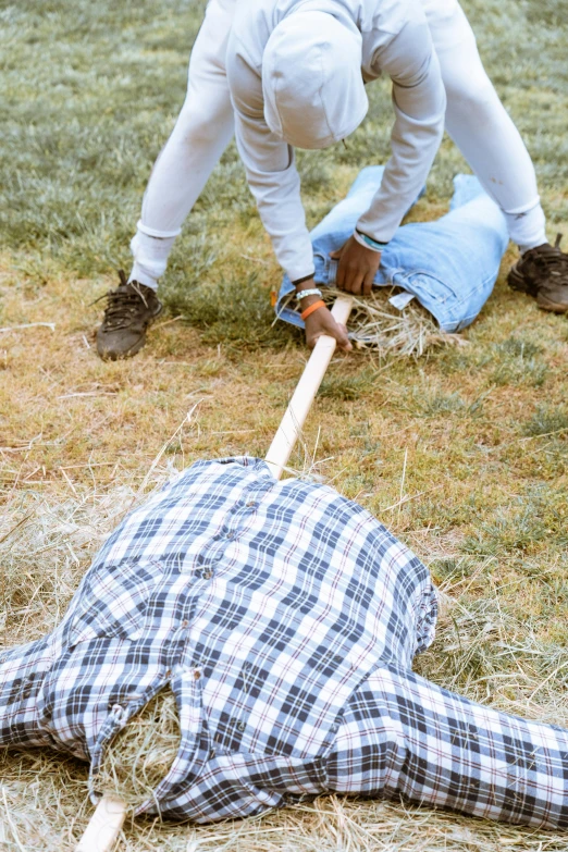 two men with a baseball bat on some grass