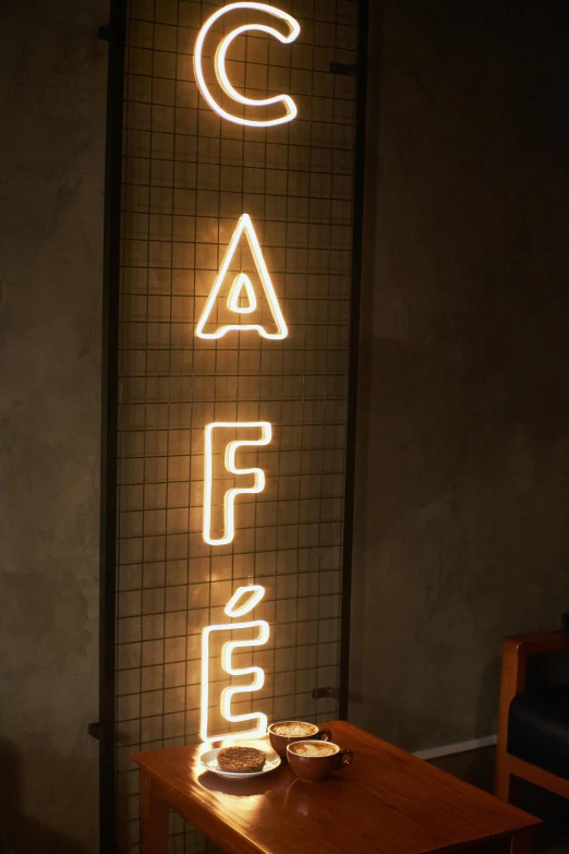 a neon sign above two plates on a table