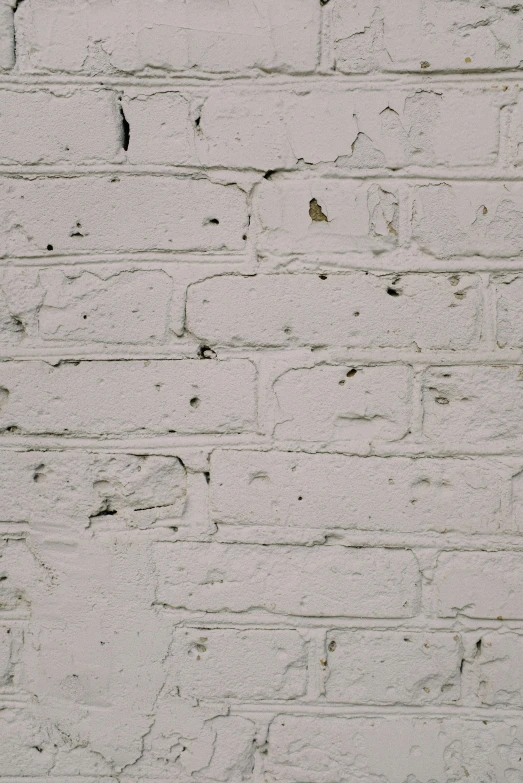 an old building with white paint on the outside wall