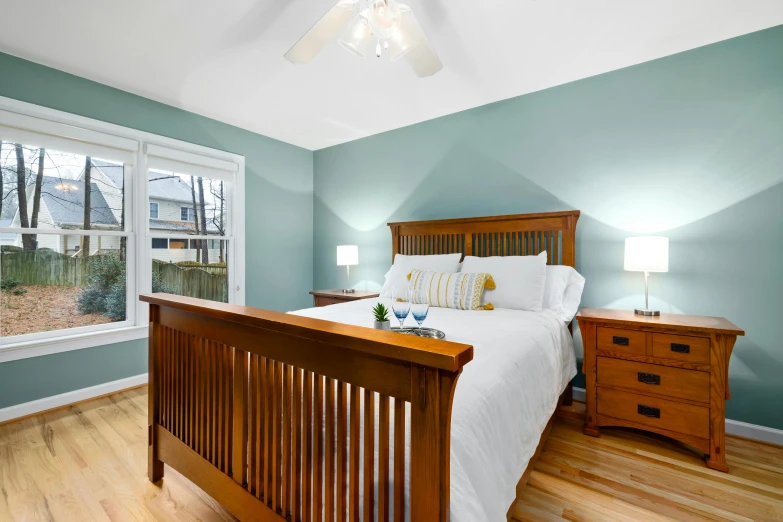 a bed and dresser in a room with wood floors