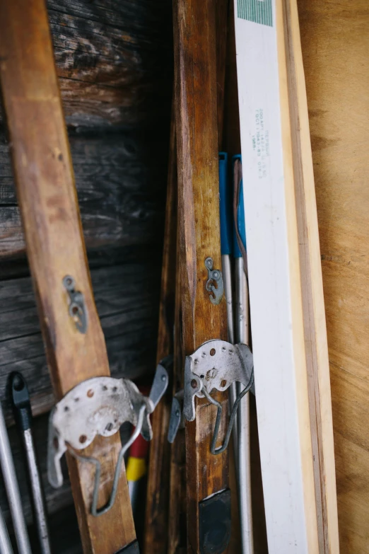 a couple of skis are hanging on a wood plank