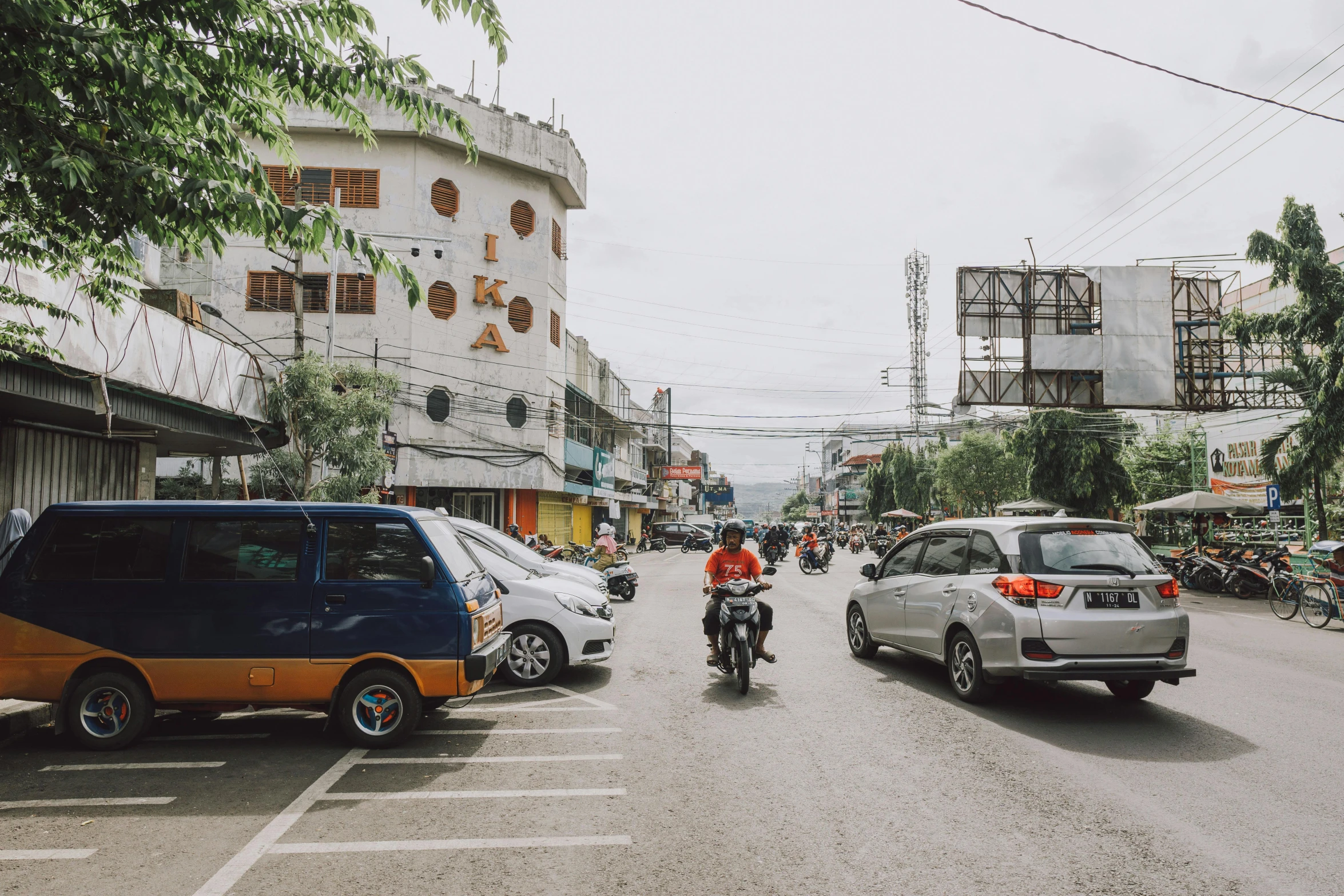 a motorcycle and cars parked on a city street