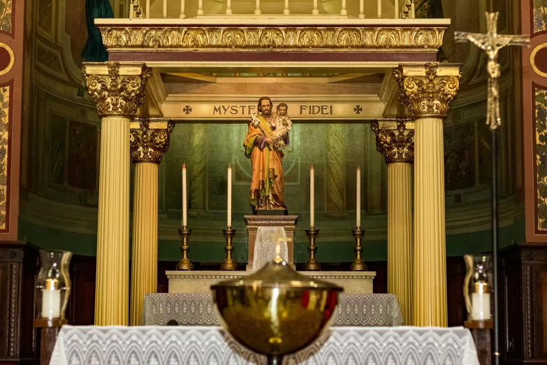 a statue is on a stand in the middle of the alter