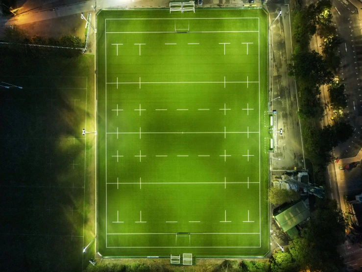 an aerial view of a soccer field, in the middle of a night time