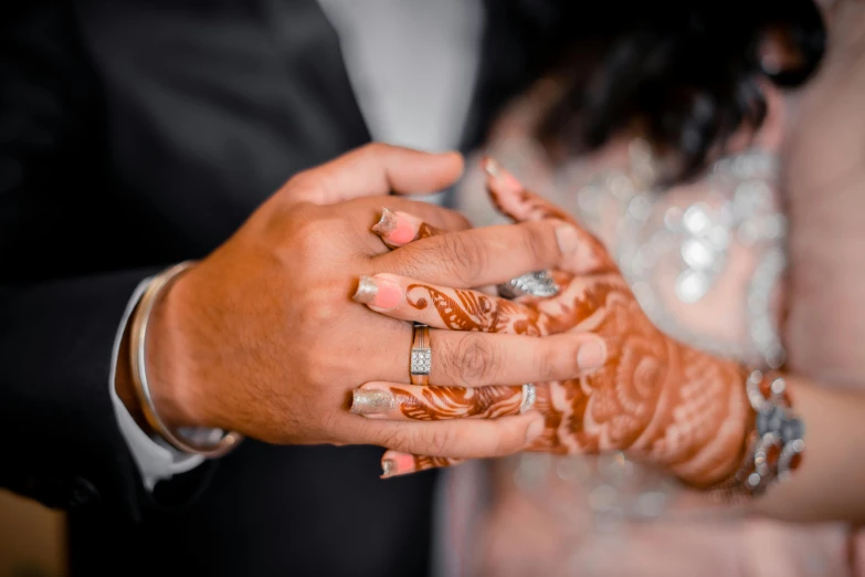 the bride and groom hold their hands near their hands