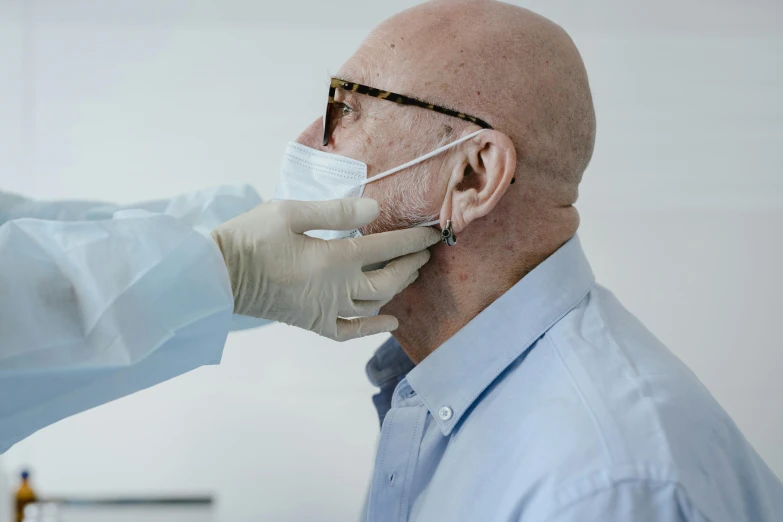 someone getting their nose examined by a doctor