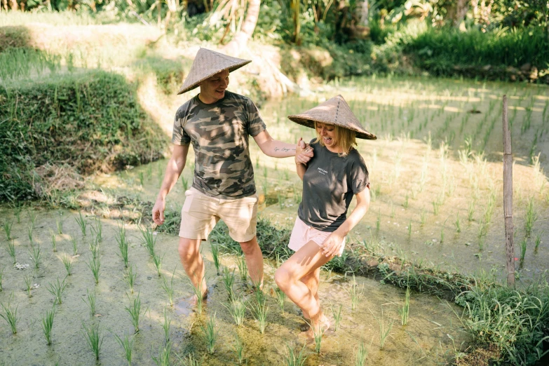 two men are walking through a grassy area together