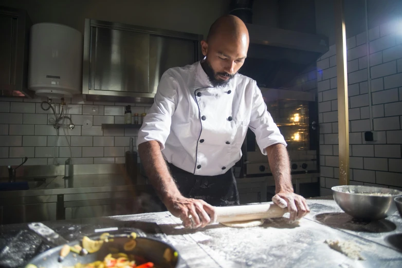 a man preparing food on top of a  board