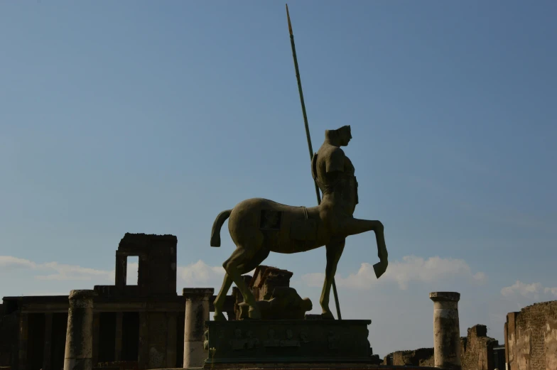 a large statue with a long flag on a horse