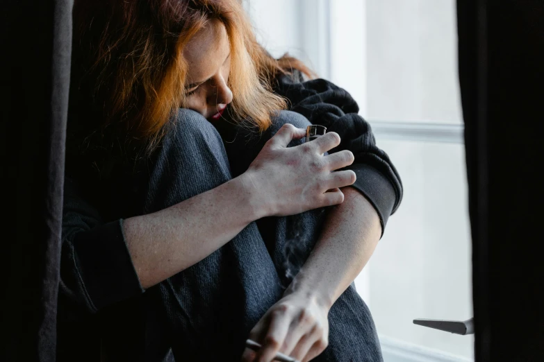 a woman is hugging another woman by the window