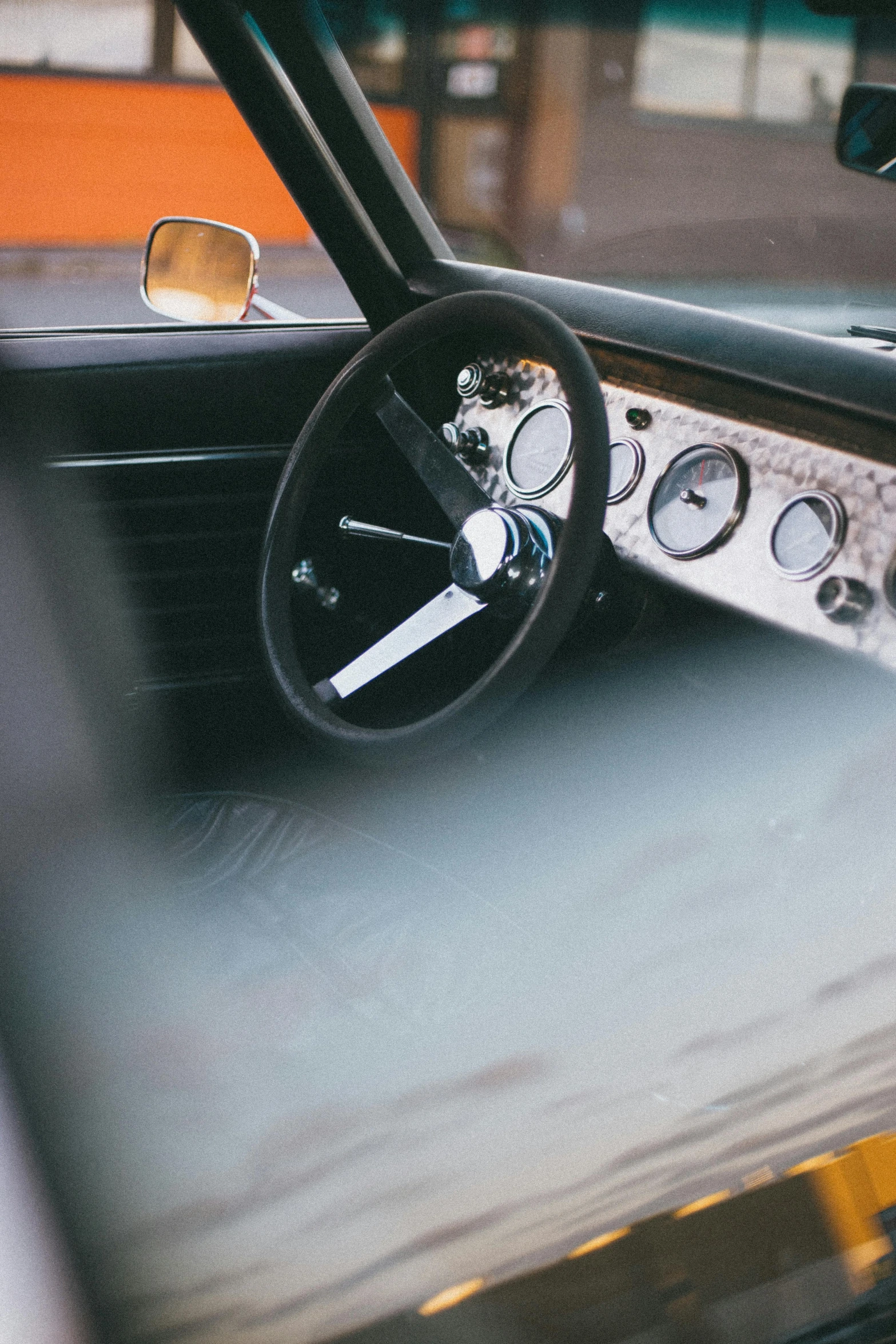 an interior s of a classic car with a steering wheel and gauges