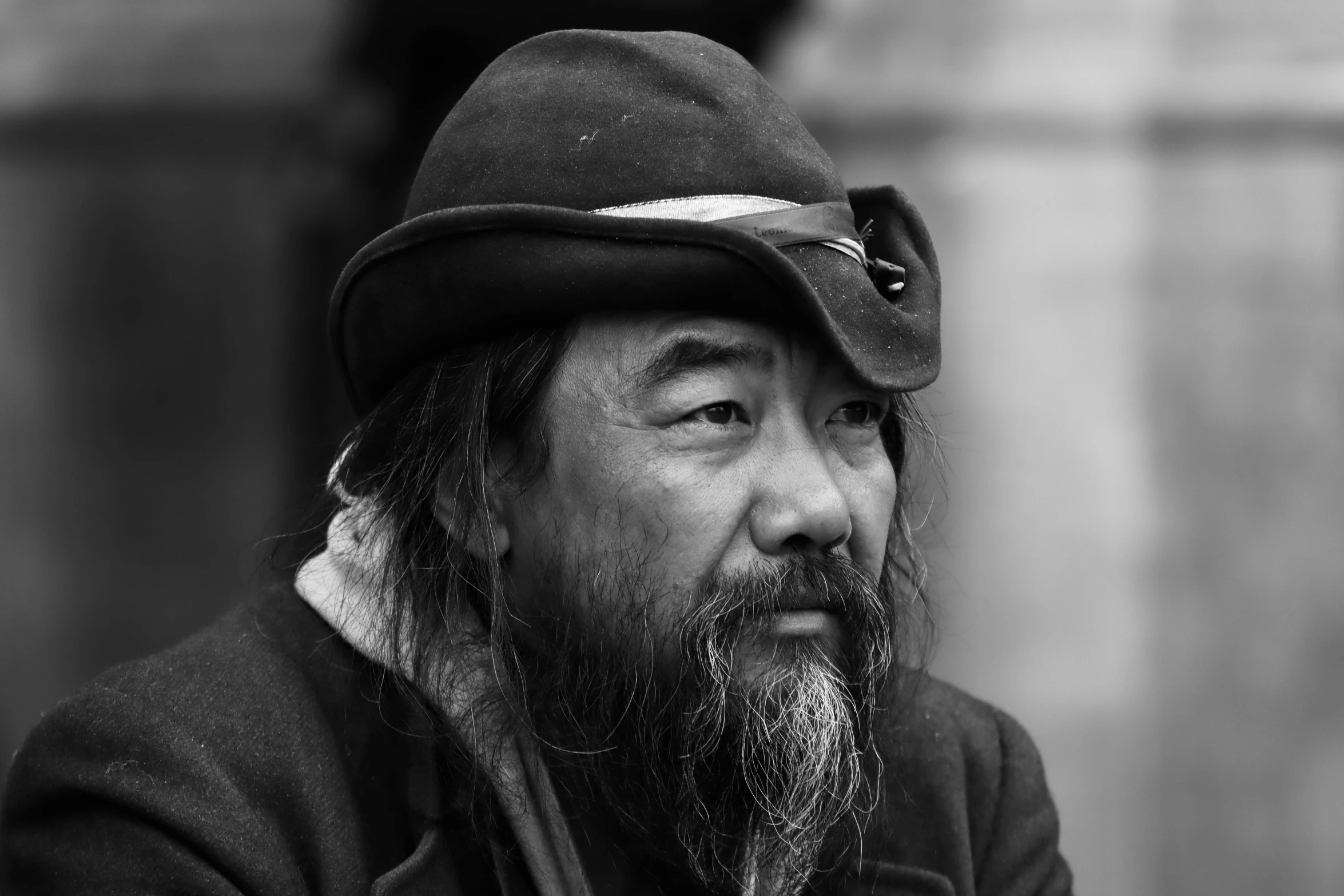 a man with a hat is standing near the street