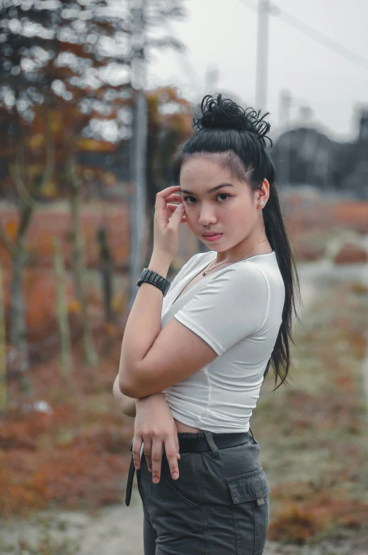 an asian woman standing in the rain and holding her hand to her ear