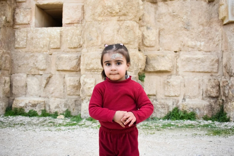 little girl in red posing for a po