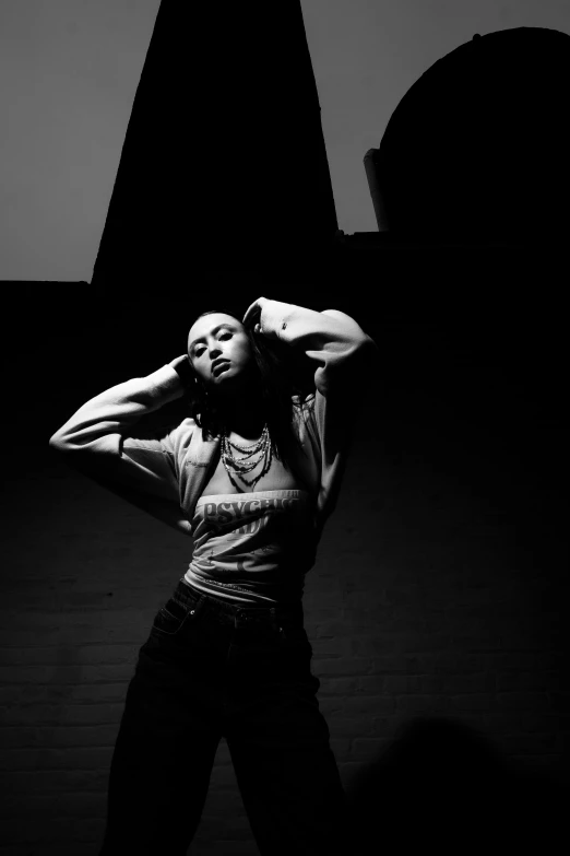 a woman is leaning against the wall in a black and white po