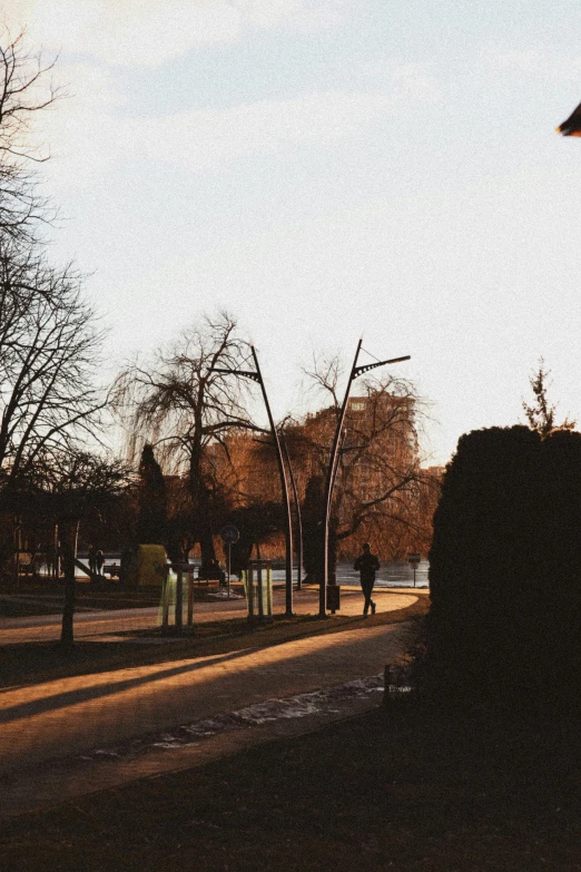 silhouette of woman riding a skateboard down a city street