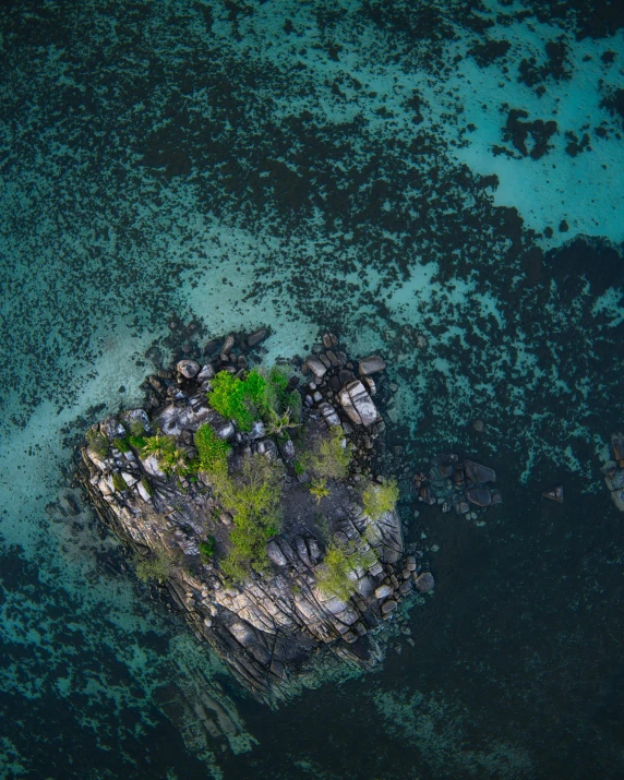 a rocky island off the shore of a blue lagoon