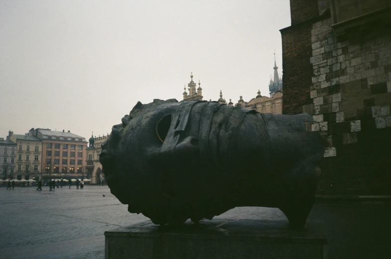 the large sculpture is next to a brick building