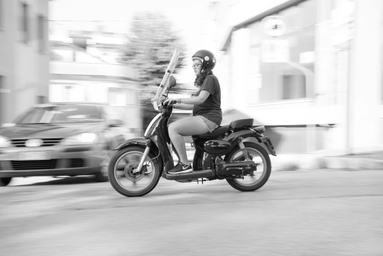 black and white pograph of a person on a motorbike