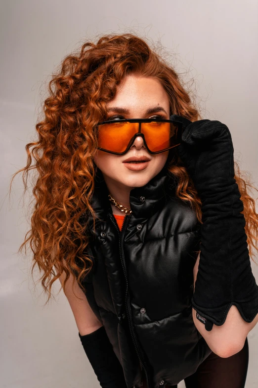 a woman with long red hair and glasses