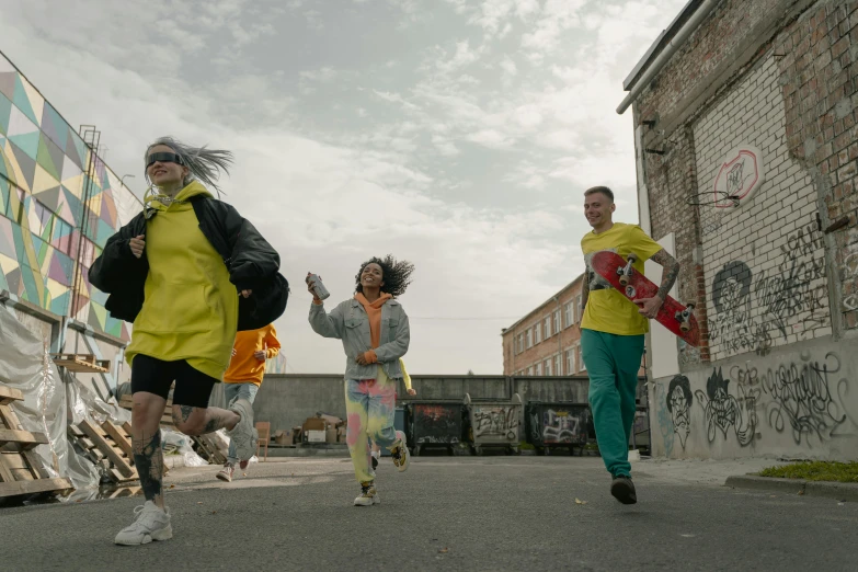 two people run across the street near some other people