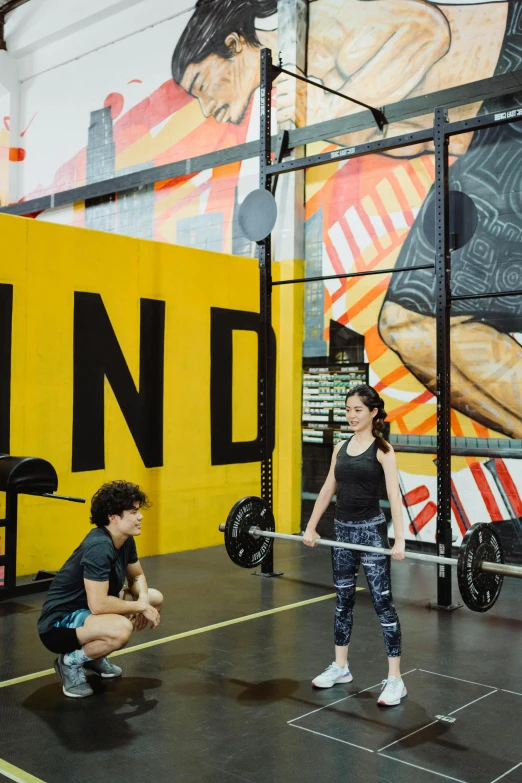 two people in the middle of an indoor gym