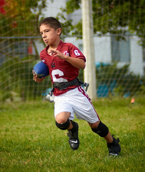  running in a soccer field with ball