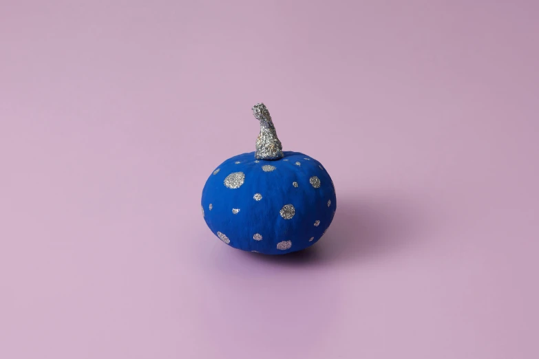 a blue ceramic pumpkin decorated with small diamonds