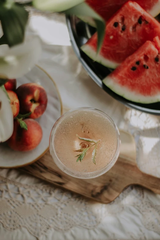 watermelon slices and some fruit in bowls sit on a tray