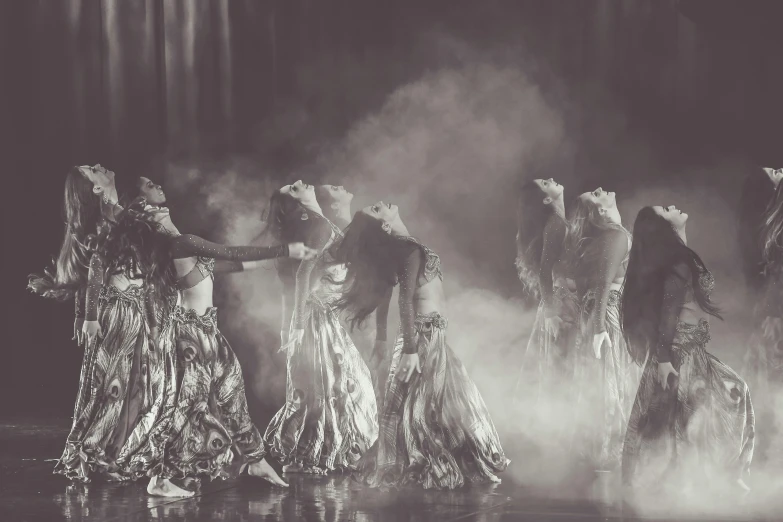 the backlit image shows women dancing while wearing white