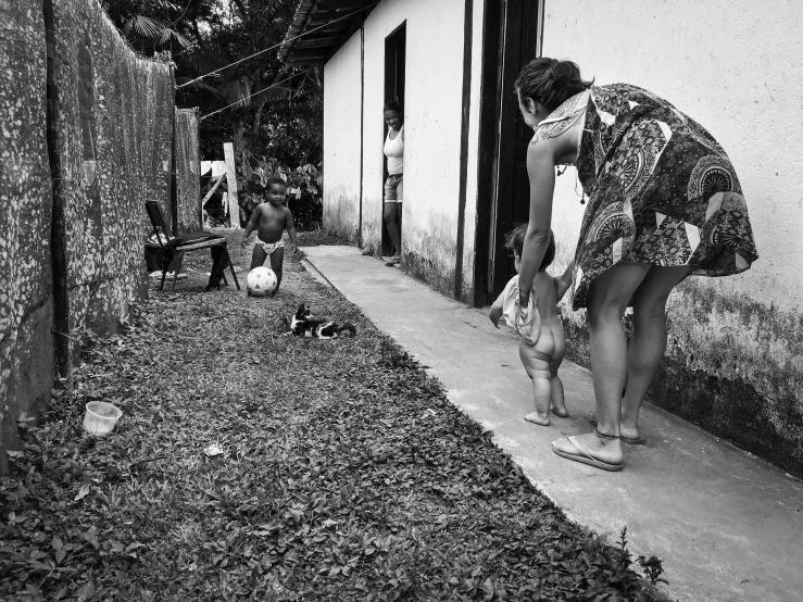 black and white pograph of woman playing with child