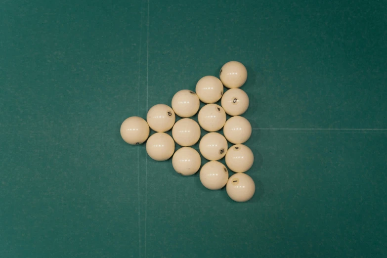 the tennis balls are on the table and a green background