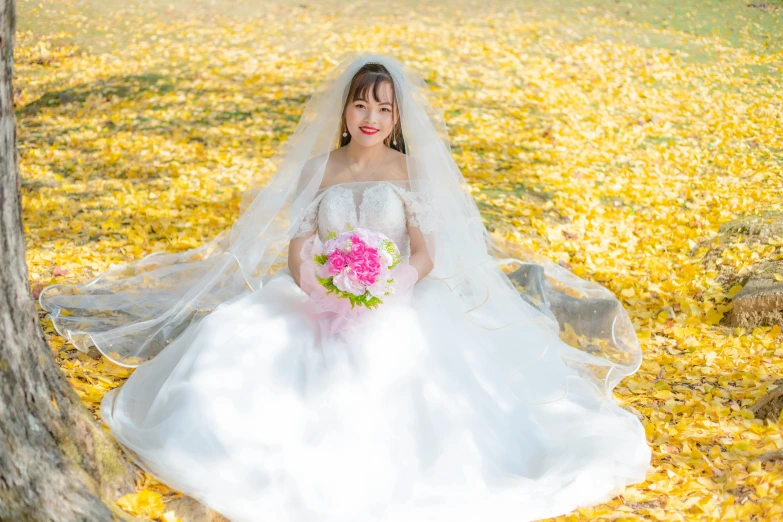 a beautiful woman in a white wedding dress holding a bouquet