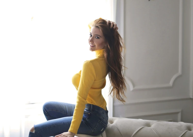 a woman sitting on top of a white couch